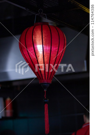 Colorful lanterns illuminate the restaurant, creating a vibrant atmosphere 114764386