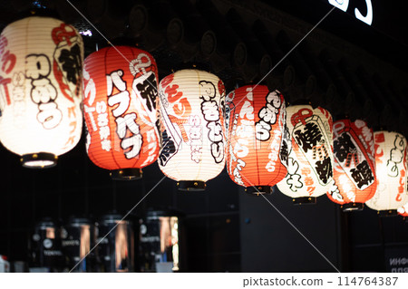 Colorful lanterns illuminate the restaurant, creating a vibrant atmosphere Colorful lanterns illuminate the restaurant, creating a vibrant atmosphere 114764387