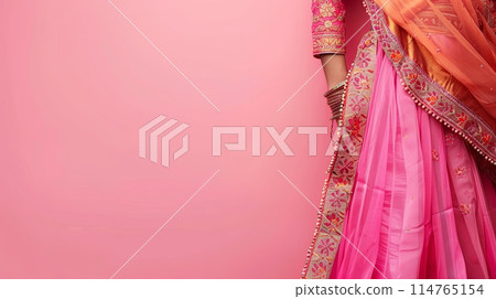 Traditional Indian women's costume dress on a pink background, copy space 114765154