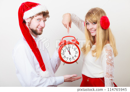 Happy couple woman and man with alarm clock. 114765945