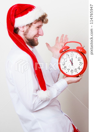 Happy man with alarm clock. Christmas time. Happy man with alarm clock. Christmas time. 114765947