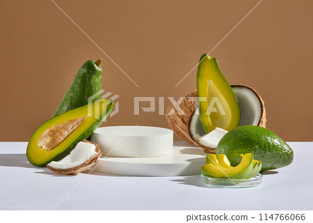 Unique template for advertising with  blank pedestal in round shaped in center, avocado and coconut are common ingredient in cosmetic and hair care products. Front view photo, blank space for text 114766066