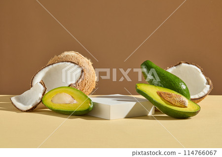 Natural cosmetic or haircare products advertising which has avocado and coconut origin, rectangular white pedestal with blank space for showing product. Front view on brown background 114766067