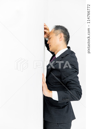 Middle-aged man, business, leaning against wall Middle-aged man, business, leaning against wall 114766772