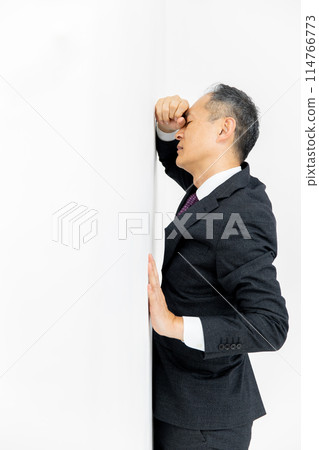 Middle-aged man, business, leaning against wall Middle-aged man, business, leaning against wall 114766773