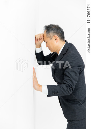 Middle-aged man, business, leaning against wall Middle-aged man, business, leaning against wall 114766774