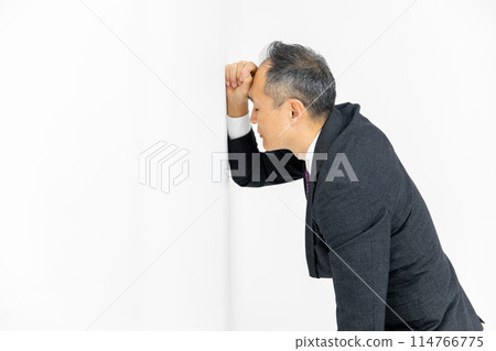 Middle-aged man, business, leaning against wall Middle-aged man, business, leaning against wall 114766775
