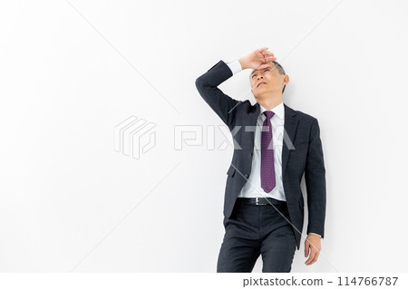 Middle-aged man, business, leaning against wall Middle-aged man, business, leaning against wall 114766787