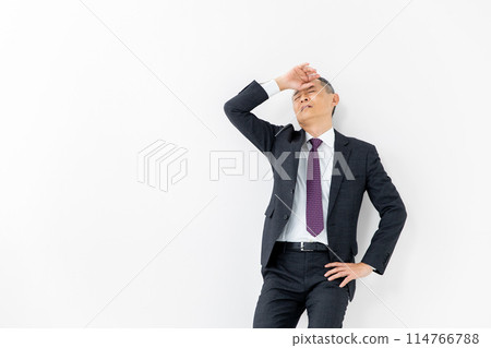 Middle-aged man, business, leaning against wall 114766788