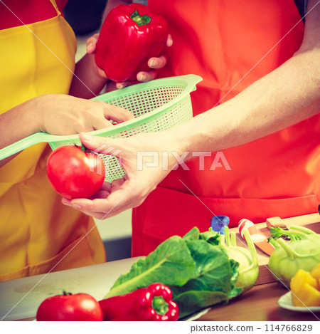 Couple preparing fresh vegetables food salad Couple preparing fresh vegetables food salad 114766829