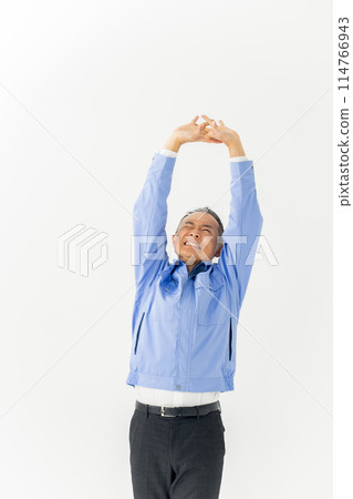 Man in work clothes stretching vertical Man in work clothes stretching vertical 114766943