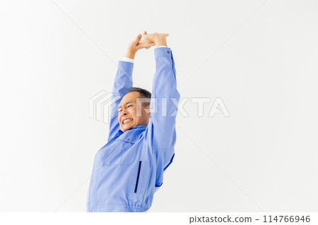 Man in work clothes stretching 114766946
