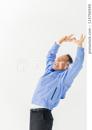 Man in work clothes stretching vertical 114766949
