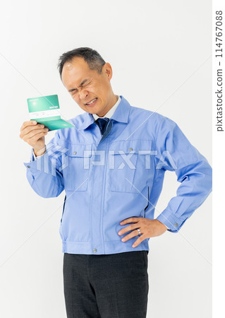 Man in work clothes, bankbook, worried, vertical 114767088