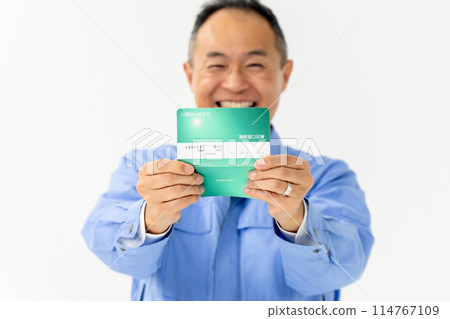 Man in work clothes, bankbook, happy Man in work clothes, bankbook, happy 114767109