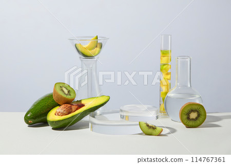 Concept laboratory tests and research with kiwis and avocados arranged with some glassware. Collection of podiums and pedestals for product presentation 114767361