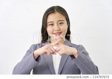 Young business woman making a cross gesture on white background 114767672