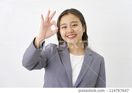 Young business woman making an OK sign on white background Young business woman making an OK sign on white background 114767687
