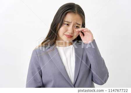 Crying young business woman white background 114767722