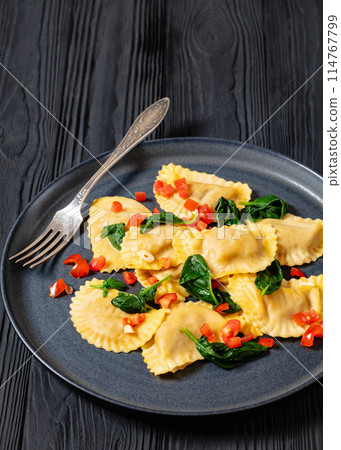 italian pasta mezzelune on a plate, top view italian pasta mezzelune on a plate, top view 114767799