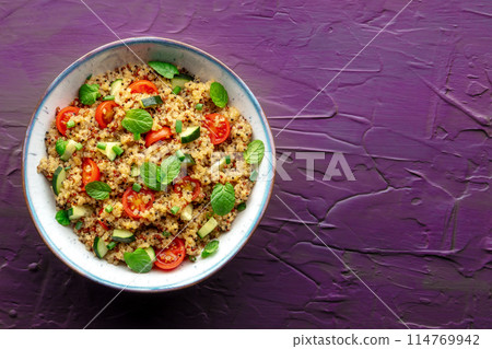 Quinoa tabbouleh salad in a bowl, a healthy dinner with tomatoes and mint Quinoa tabbouleh salad in a bowl, a healthy dinner with tomatoes and mint 114769942