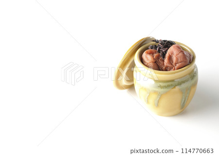 Pickled plums and red shiso in a jar photographed on a white background Pickled plums and red shiso in a jar photographed on a white background 114770663