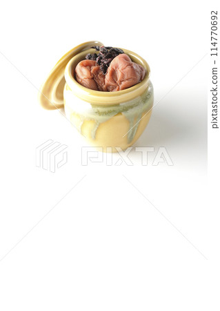 Pickled plums and red shiso in a jar photographed on a white background Pickled plums and red shiso in a jar photographed on a white background 114770692
