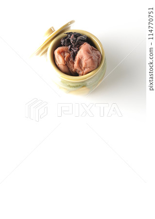 Aerial view of pickled plums and red shiso in a jar on a white background 114770751