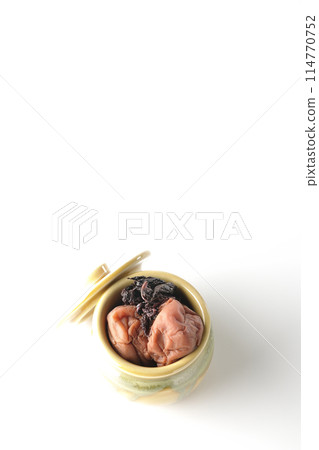 Aerial view of pickled plums and red shiso in a jar on a white background 114770752