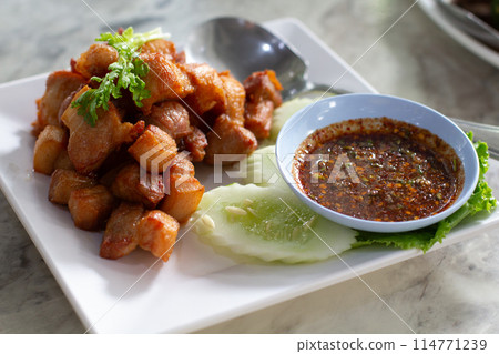 Deep-fried pork belly with fish sauce and spicy dipping sauce,It will be an appetizer. Or it can be a main course and eaten with steamed rice. Deep-fried pork belly with fish sauce and spicy dipping sauce,It will be an appetizer. Or it can be a main course and eaten with steamed rice. 114771239