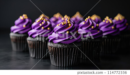 Row chocolate cupcakes with violet frosting golden pearls on dark background, minimalism, copy space 114772336