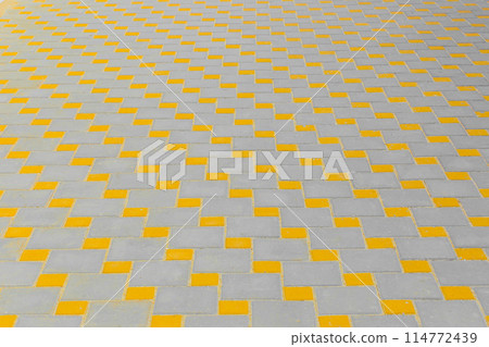Abstract pattern of yellow and grey pavement tile street road surface city texture background paving 114772439