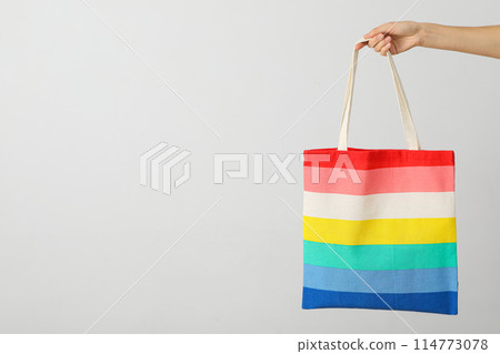 Concept of lgbt parade, rainbow shopper, on color background. 114773078