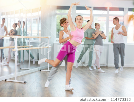 Boy and girl in pair train to perform ballet dance during rehearsal in studio Boy and girl in pair train to perform ballet dance during rehearsal in studio 114773353