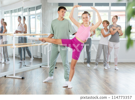 Boy and girl in pair train to perform ballet dance during rehearsal in studio 114773357