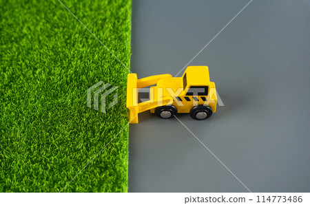 The bulldozer removes the grass and leaves the concrete. The concept of destruction of nature for technogenic development. Expanding cities space . Urbanization, increasing influence on environment. The bulldozer removes the grass and leaves the concrete. The concept of destruction of nature for technogenic development. Expanding cities space . Urbanization, increasing influence on environment. 114773486