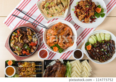 Assorted Asian dishes on wooden table 114773752