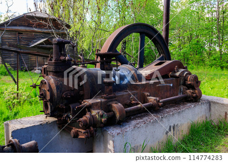 Old steaming threshing machine in Open air Museum of Folk Architecture and Folkways of Middle Naddnipryanschina in Pereyaslav, Ukraine Old steaming threshing machine in Open air Museum of Folk Architecture and Folkways of Middle Naddnipryanschina in Pereyaslav, Ukraine 114774283