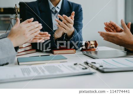 Teamwork of business lawyer meeting working hard about legal legislation in courtroom to help their customer. Teamwork of business lawyer meeting working hard about legal legislation in courtroom to help their customer. 114774441