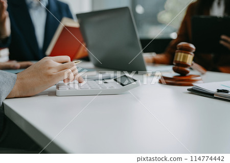 Teamwork of business lawyer meeting working hard about legal legislation in courtroom to help their customer. Teamwork of business lawyer meeting working hard about legal legislation in courtroom to help their customer. 114774442