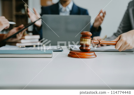 Teamwork of business lawyer meeting working hard about legal legislation in courtroom to help their customer. Teamwork of business lawyer meeting working hard about legal legislation in courtroom to help their customer. 114774448