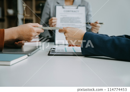 Teamwork of business lawyer meeting working hard about legal legislation in courtroom to help their customer. Teamwork of business lawyer meeting working hard about legal legislation in courtroom to help their customer. 114774453