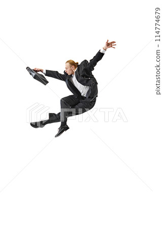 Business professional in suit performing dynamic leap. Swift and decisive movements required for success in corporate world. 114774679