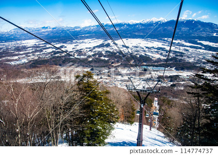 Beautiful scenery of a moving gondola at a ski resort on a sunny day Beautiful scenery of a moving gondola at a ski resort on a sunny day 114774737