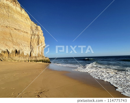 Beautiful seascape with beach, cliffs and ocean. Ferragudo, Portugal 114775743