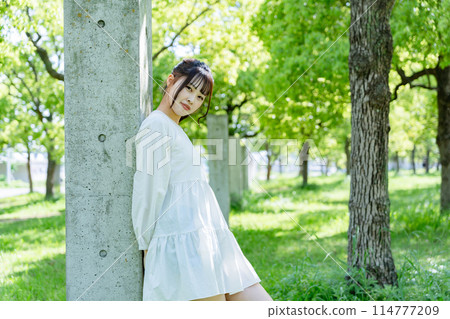 A woman relaxing in the park 114777209
