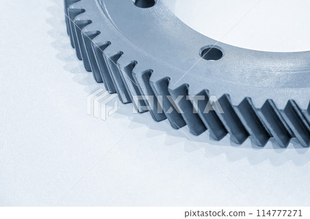 Close up scene the helical  gear parts spare parts in the light blue scene. 114777271