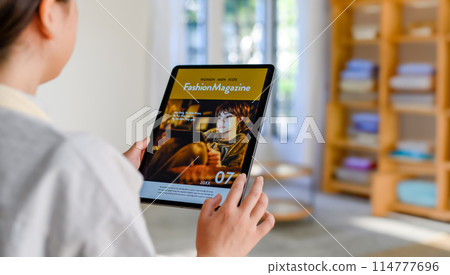 A woman who operates a tablet 114777696
