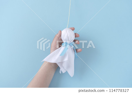 Holding a Teru Teru Bouzu 114778327