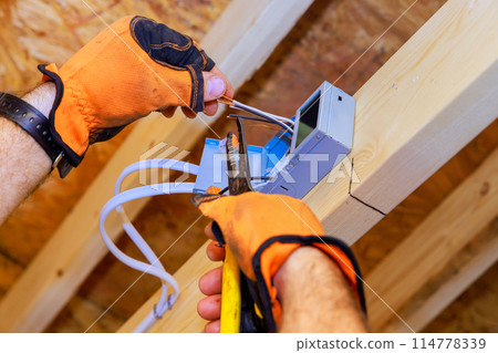 New home construction: installation of recessed ceiling lights with LEDs New home construction: installation of recessed ceiling lights with LEDs 114778339